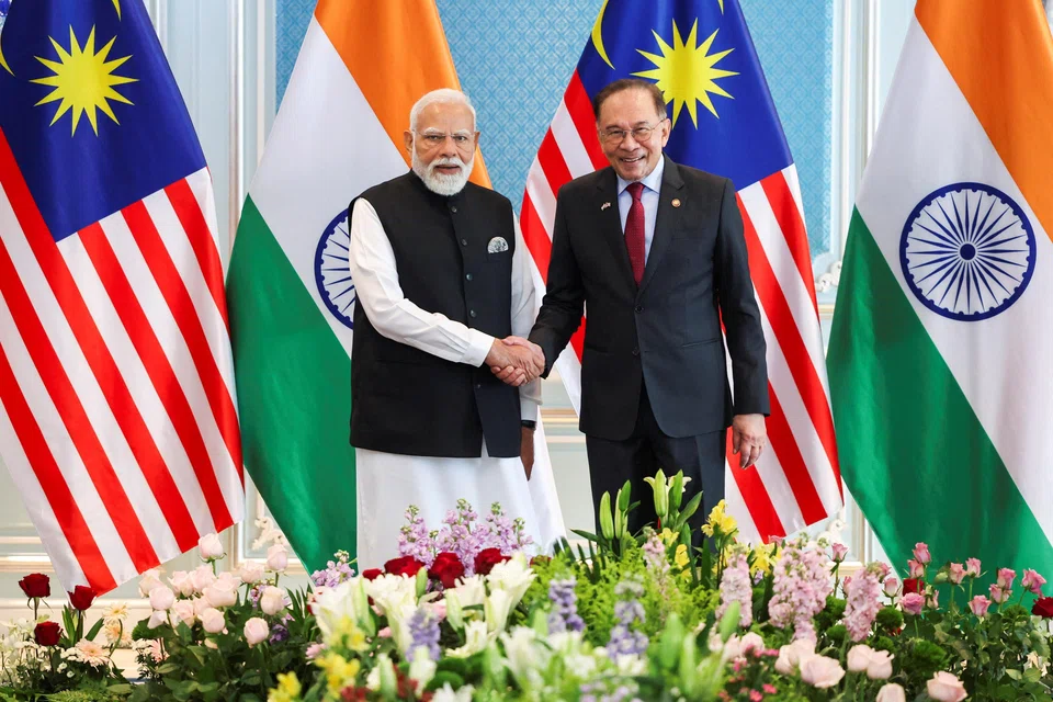 Malaysian Prime Minister Anwar Ibrahim shakes hands with Indian Prime Minister Narendra Modi, on the second day of Modi's official visit, in Putrajaya, Malaysia on Feb 8.