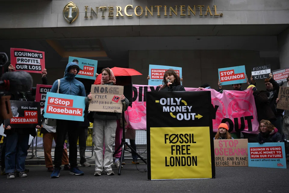 Climate activists hold placards during a protest against the Rosebank oil field project in the North Sea off the coast of Scotland on Oct 18, 2023