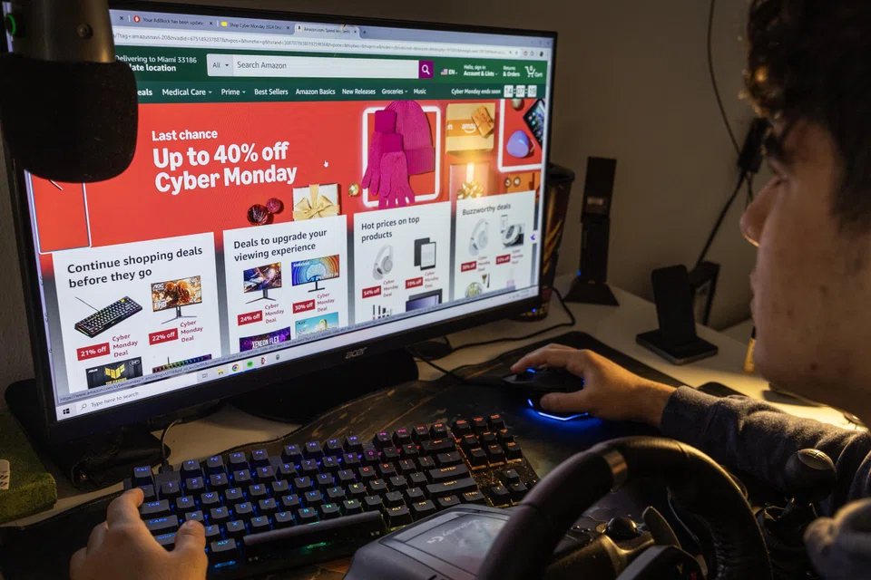 A person searches for specials on a computer during the Cyber Monday shopping event in Miami, Florida, Dec 2, 2024. 