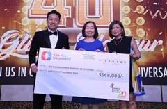 Kim Yew managing director Patrick Tan (left) presents a cheque to BT editor Chen Huifen (centre) and TRCL's head of partnership development Elaine Tan.