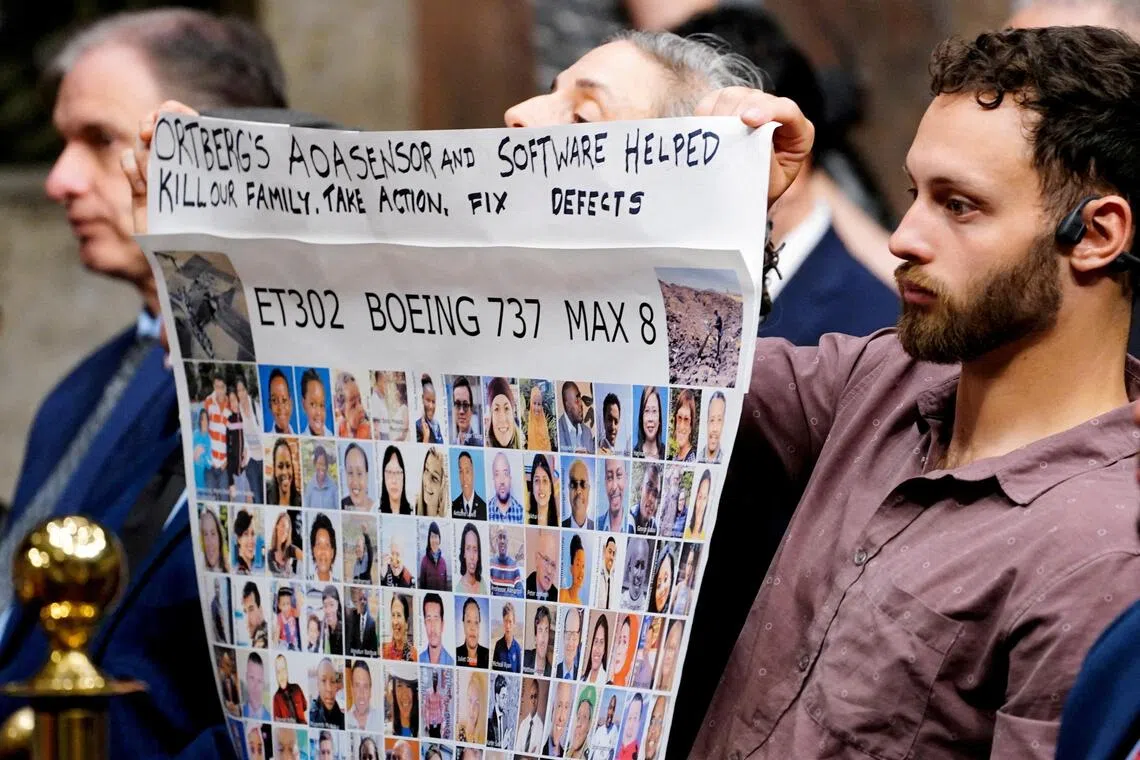 People hold a banner with pictures of victims of crashed Ethiopian Airlines flight 302 Boeing 737 MAX 8 during Senate Commerce, Science and Transportation Committee hearing about Boeing’s commitment to address safety concerns in the wake of a Jan 2024 mid-air emergency involving a new 737 MAX, on Capitol Hill in Washington, D.C., April 2, 2025. 