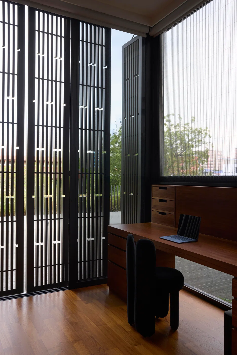 Adjustable screens provide privacy to the second-storey study room facing the street. 