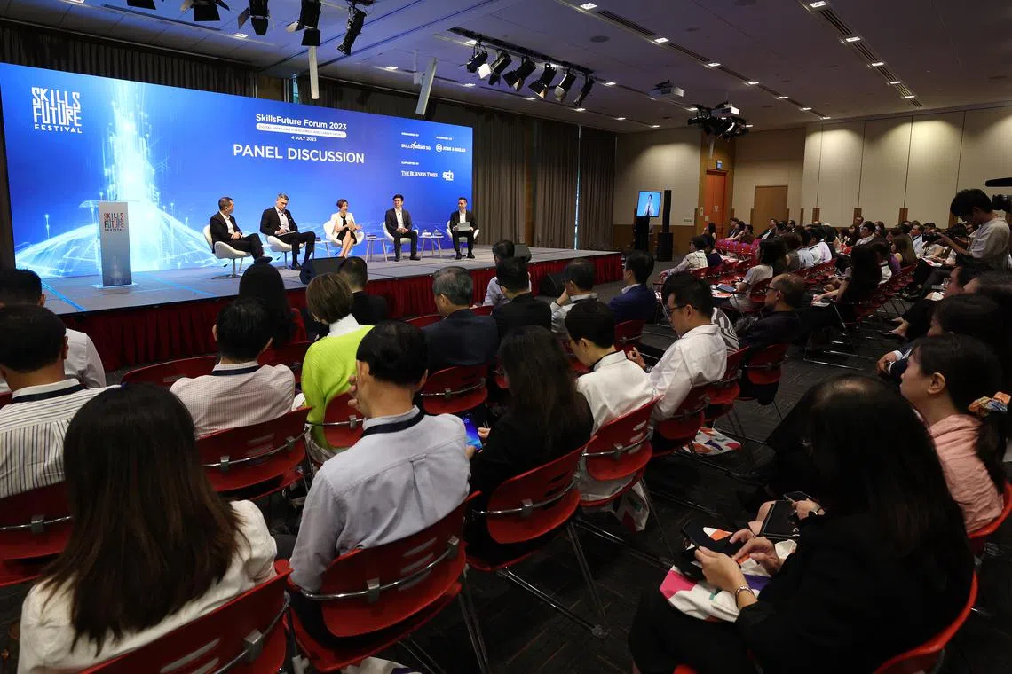 At  the forum. The panellists are from left: Tan Kok Yam, chief executive of SkillsFuture Singapore; Aslam Sardar, CEO of the Institute for Human Resource Professionals; Lee Hui Li, managing director of Microsoft Singapore; Lee Kian Chong, CEO of Deli in the Park; and moderator Christopher Lim, associate editor for product at The Business Times.