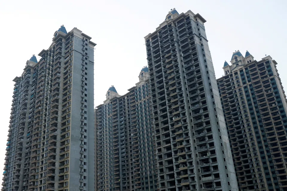 FILE PHOTO: Unfinished residential buildings are pictured at the Evergrande Oasis, a housing complex developed by Evergrande Group, in Luoyang, China September 15, 2021. REUTERS/Carlos Garcia Rawlins/File Photo
