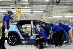 Workers assemble an electric vehicle in Rayong, Thailand, July 4, 2024.