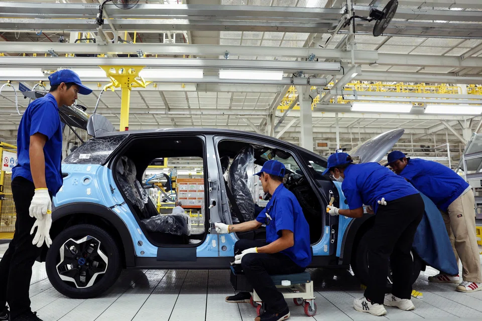 Workers assemble an electric vehicle in Rayong, Thailand, July 4, 2024.