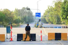 Police officers stand guard on a road in Islamabad on Apr 21, as Pakistan prepares to host the US and Iran for the second phase of peace talks.