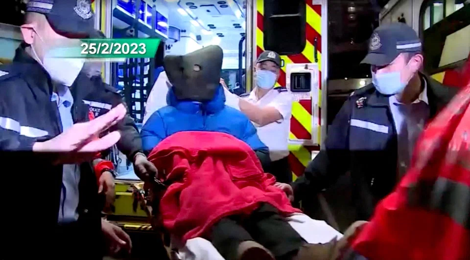 A 28-year-old suspect in the murder of model Abby Choi is taken to a hospital in a hood after getting arrested by the Hong Kong police, in Hong Kong, China, Feb 25, 2023. Four people charged in connection with the killing of 28-year-old model Abby Choi appeared in court on Monday morning.