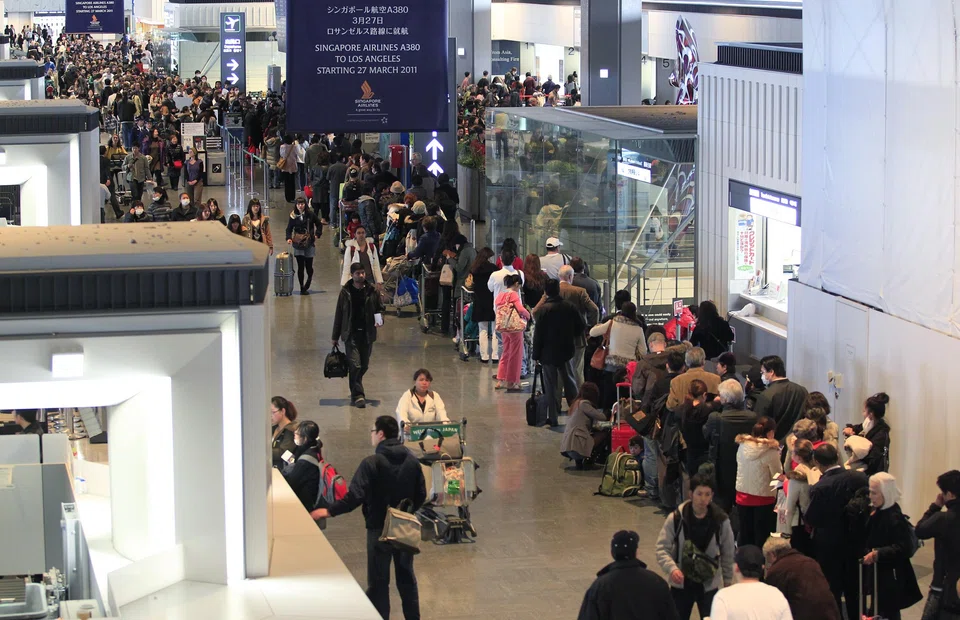 File photo of passengers at Narita airport. One runway at Narita airport has been closed due to the emergency landing of a cargo plane, public broadcaster NHK reported on Tuesday.