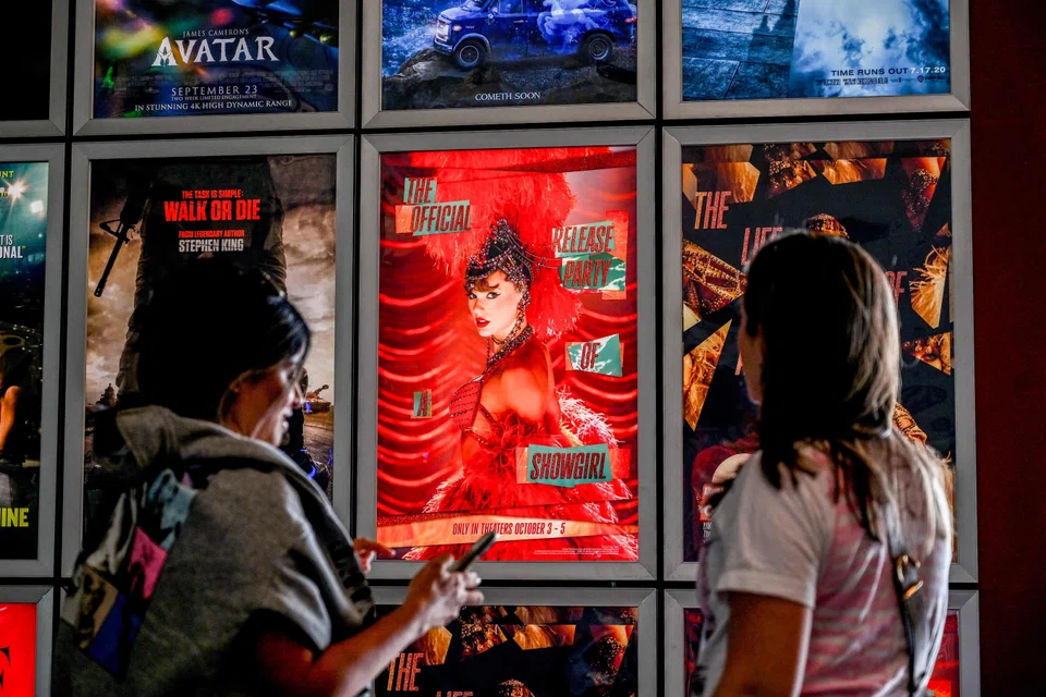 Fans take pictures as they attend "Taylor Swift: The Official Release Party of a Showgirl" at AMC Montgomery 16 movie theatre in Bethesda, Maryland, Oct 3, 2025. 