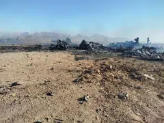 A handout picture provided by Iran's Revolutionary Guard Corps showing the wreckage and remains of a downed US aircraft in central Iran.
