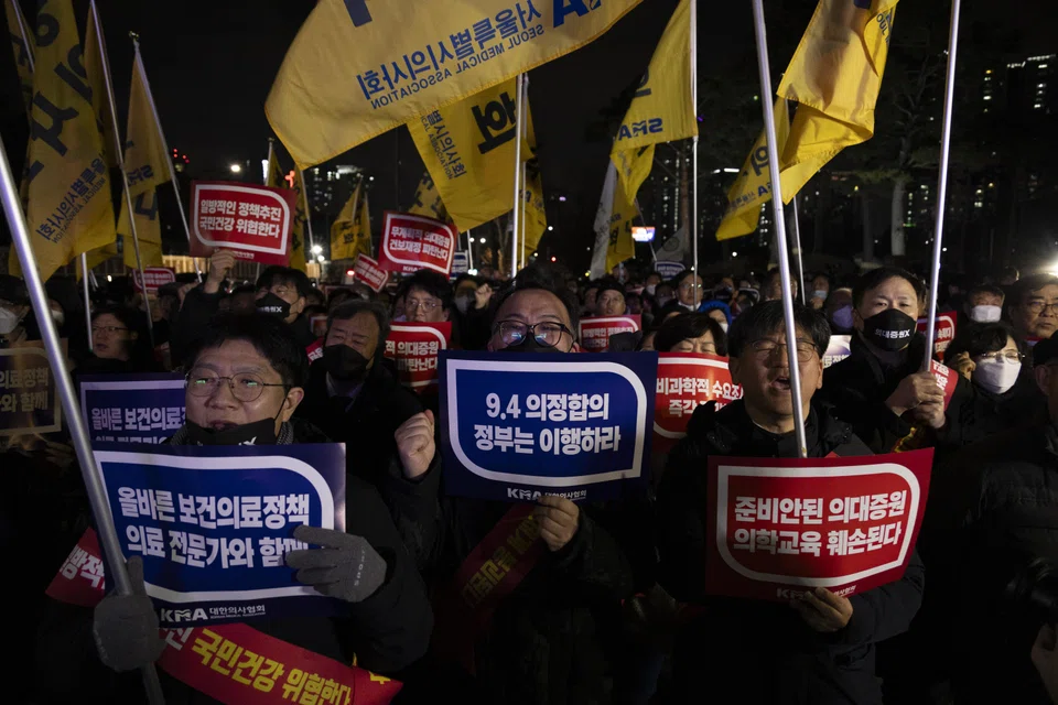 Doctors shout slogans and carry signs reading 'Opposition to the increase in medical schools' during a protest against the government's medical policy, near the presidential office in Seoul, South Korea, Feb 15, 2024. 