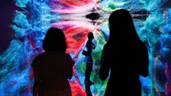 Visitors are pictured in front of an immersive art installation titled "Machine Hallucinations - Space: Metaverse" by media artist Refik Anadol, which will be converted into NFT and auctioned online at Sotheby's, at the Digital Art Fair, in Hong Kong, China September 30, 2021. REUTERS/Tyrone Siu     TPX IMAGES OF THE DAY##########pic##########