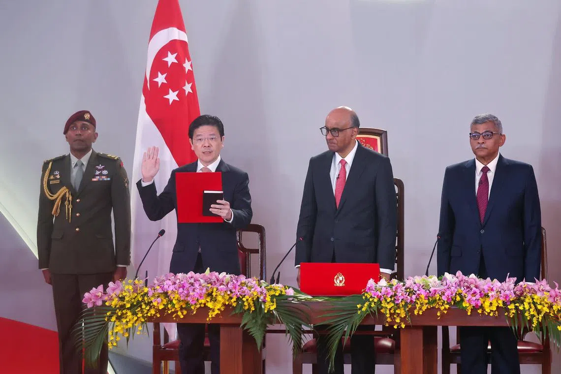 President Tharman Shanmugaratnam (third from left) and Chief Justice Sundaresh Menon (fourth from left) look on as PM Lawrence Wong is sworn in at the Istana. At the ceremony, PM Wong laid out the priorities for the new term of government.