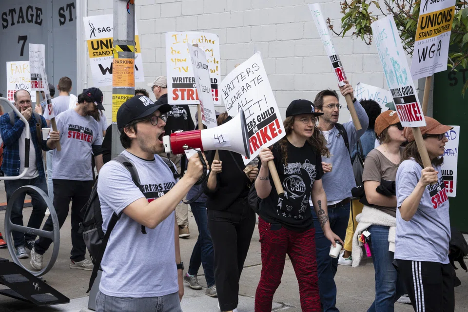 Members of the Writers Guild of America and supporters picket outside a sound stage at Brooklyn Stages where the "FBI" television show was filming in New York, May 5, 2023. Among the writers’ demands is that studios will not let artificial intelligence encroach on writers’ credit or compensation. 
