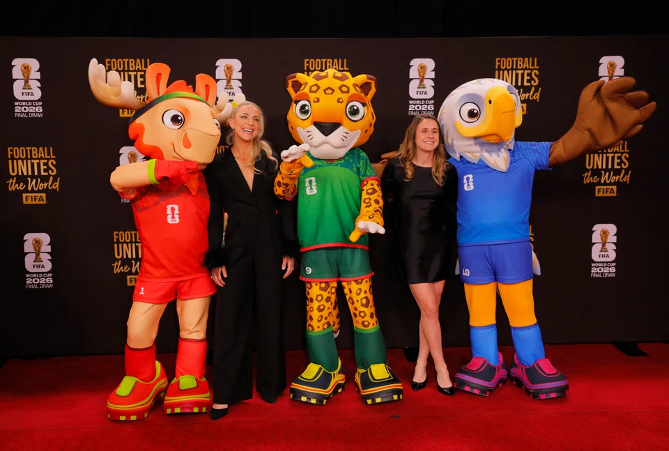 The World Cup 2026 mascots Maple the Moose of Canada, Zayu the Jaguar of Mexico and Clutch the Bald Eagle of the US, together with former US footballers Julie Ertz and Heather O'Reilly at the draw ceremony in Washington in December 2025.