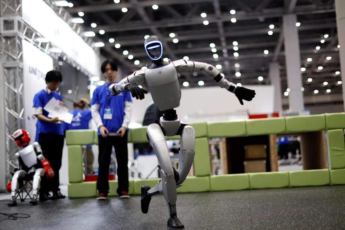 A humanoid robot made by Unitree Robotics dancing at iREX 2025. When a robot-engendered crisis arises, there may be a temptation to frame the issue in the same terms as an immigration debate, says the writer; all the more so if the humanoids are identifiably foreign in their manufacture.