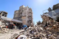 Damaged residential buildings in Karaj, Iran, after an airstrike. The country's foreign minister says attacks on civilian structures “will not compel Iranians to surrender”. 