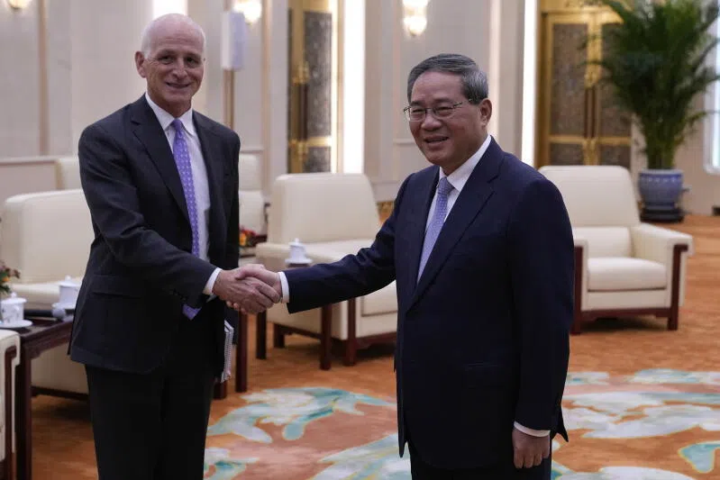 Representative Adam Smith (L), a Democratic representative from Washington, poses for a photo with Chinese Premier Li Qiang at the Great Hall of the People in Beijing.