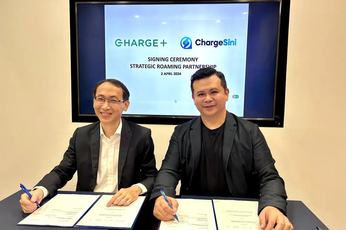 Charge+ chief executive Goh Chee Kiong (left) and ChargeSini founder and CEO James Goh signing the agreement to facilitate cross-border charging for customers of both companies. 