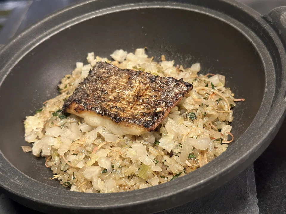 Donabe of Japanese rice, herbs and char-grilled tilefish.
