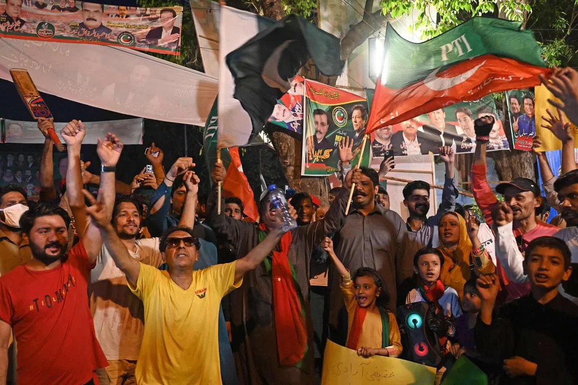 Supporters of former Pakistan's Prime Minister, Imran Khan, gather at Zaman Park in Lahore. Khan’s ouster in April last year has galvanised support for the former international cricket star as the unsteady coalition that replaced him struggles to pull Pakistan back from the brink of default and control spiralling inflation.