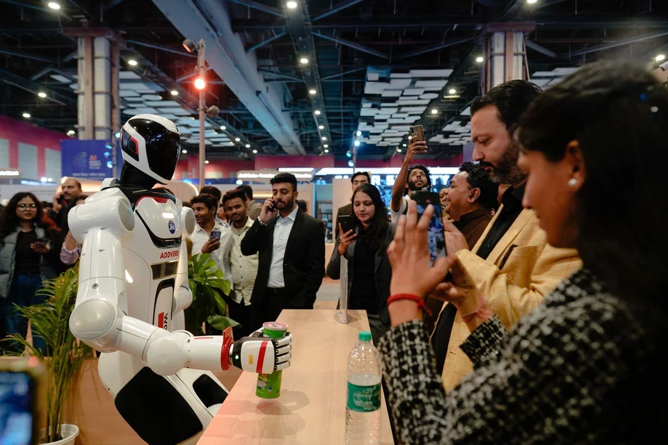 A robot interacting with visitors at the AI Impact Summit in New Delhi, which brought together representatives from more than 100 countries. 