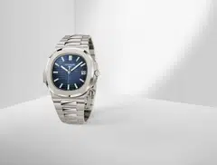 The Patek Philippe Nautilus 5811 comes in white gold and has a sunburst dial with a black gradient rim.