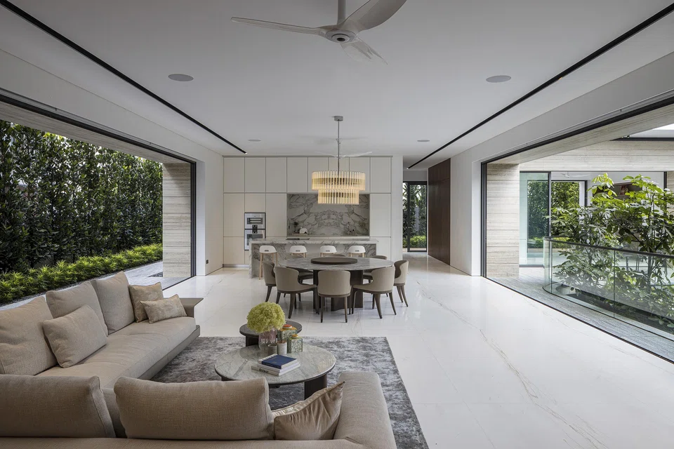 The living and dining areas open out on both sides to the outdoors.