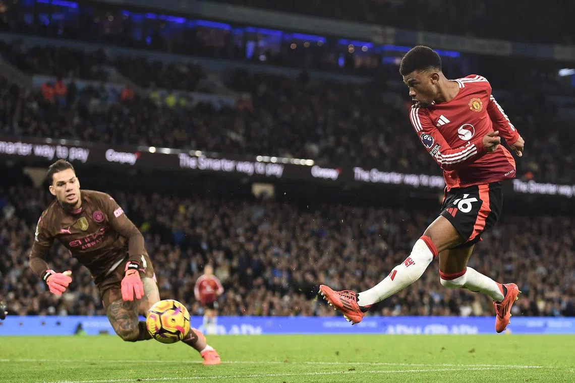 Manchester United's Amad Diallo (right) scores against Manchester City's goalkeeper Ederson to make it 2-1 in Manchester, Britain, Dec 15, 2024. 