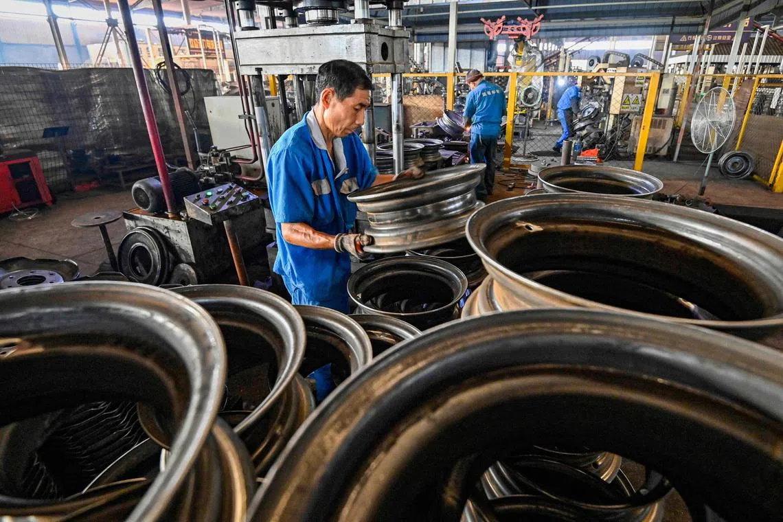Employees work on a steel wheel production line at a factory in China's Shandong province.. A high level of tariffs may be imposed on China imports into the US. This impact may spill over into Asian economies with relatively high exposure to China.