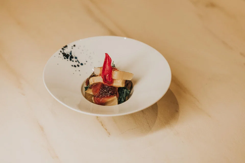 Cold grilled penshell and lotus root covered with a dollop of tart roselle tea jelly.