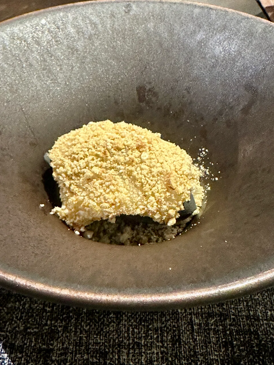 Homemade muah chee draped over black sesame ice cream.