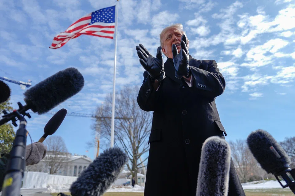US President Donald Trump speaks to the media at the White House before boarding Marine One in Washington, Jan 27, 2026. 