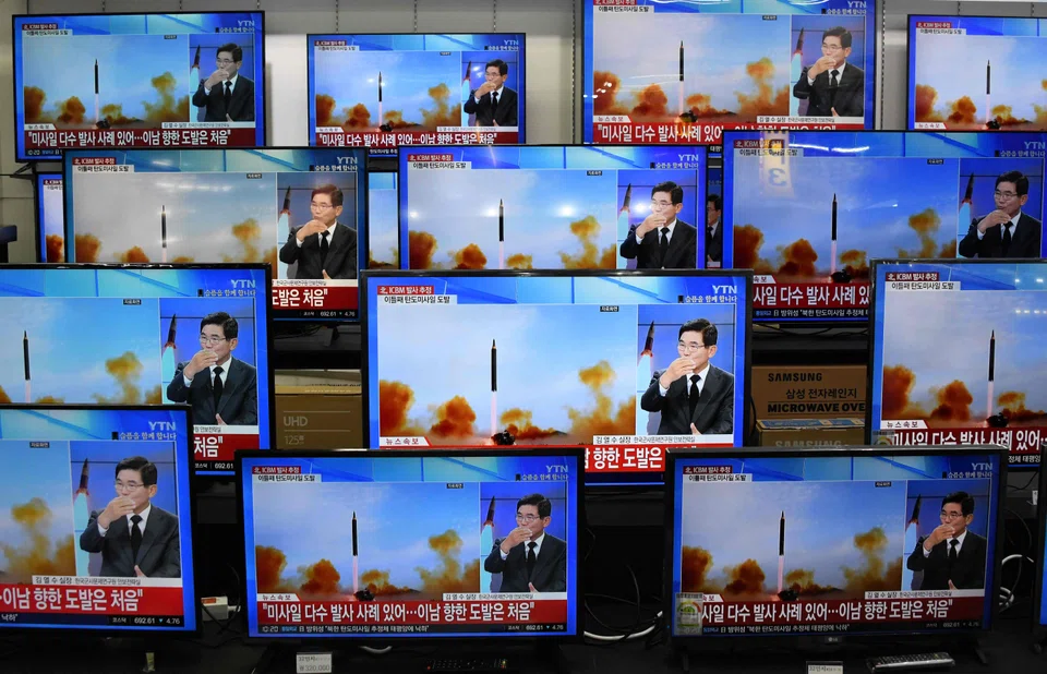 Television screens show a news report about a North Korean missile launch at an electronics store in Seoul on Nov 3, 2022. North Korea fired an artillery barrage into a maritime “buffer zone” overnight, Seoul’s military said on Friday.