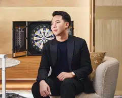 Leong Yong Shin, co-founder of Augmentus, wears a Louis Vuitton black pullover, black suit, black moccasins and Escale rose gold in silver dial watch. 