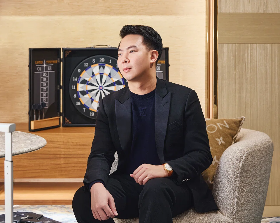 Leong Yong Shin, co-founder of Augmentus, wears a Louis Vuitton black pullover, black suit, black moccasins and Escale rose gold in silver dial watch. 
