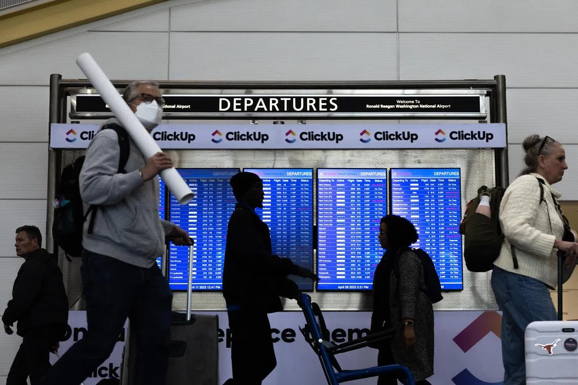 A masked traveller at Ronald Reagan Washington National Airport in Arlington, Virginia, April 28, 2023. While Covid-19 mandates and lockdowns are long gone, the virus isn't.