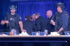 US President Trump is escorted out as a shooter opens fire during the White House Correspondents' Association dinner in Washington on Apr 25.