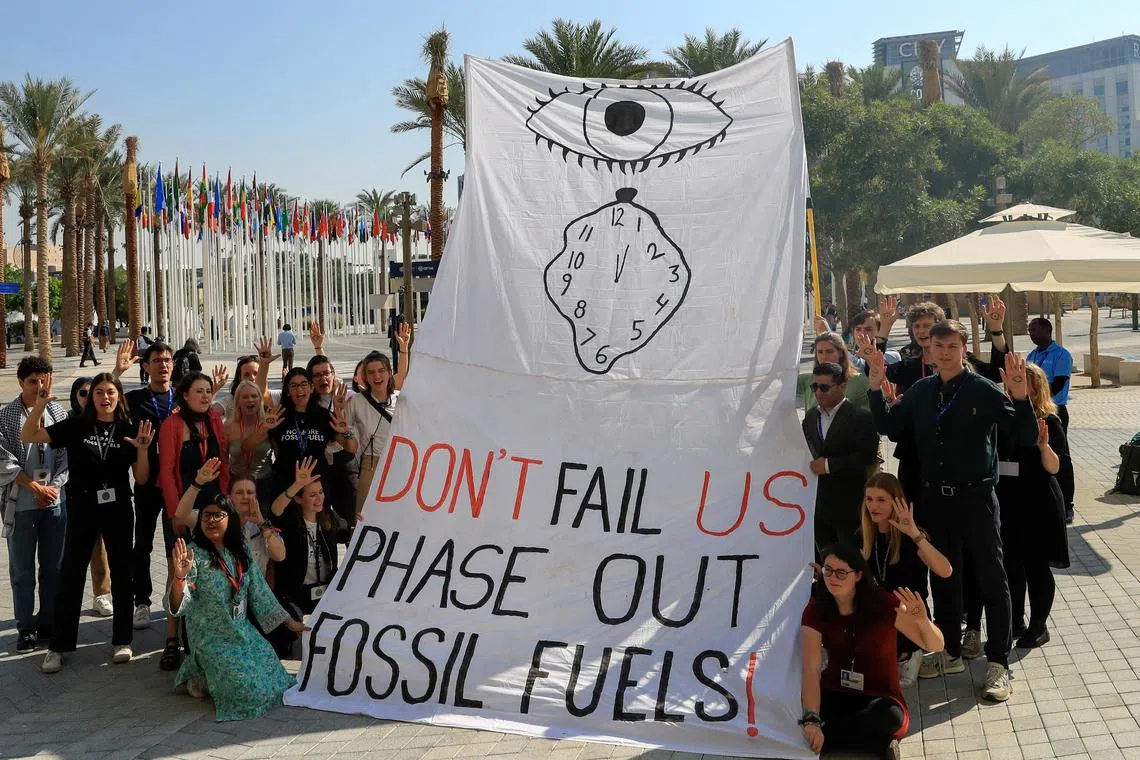 A protest against fossil fuels at Dubai's Expo City during the UN Climate Change Conference COP28 in Dubai, United Arab Emirates, Dec 2023. Phasing out fossil fuels is a good idea, but how to make it happen?  