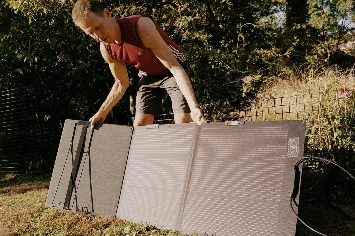 Joshua Spodek packs up his solar panel after four hours of charging in Washington Square Park in New York on Oct 22, 2024. In May 2022, Spodek disconnected his Greenwich Village apartment from the electrical grid to see if he could live unplugged for a year. 