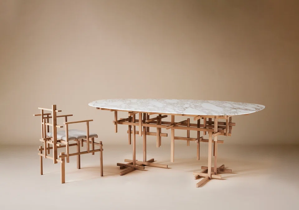 Calacatta marble is layered upon an intricate frame of white oak, designed to create dynamic shadows according to shifting sunlight.