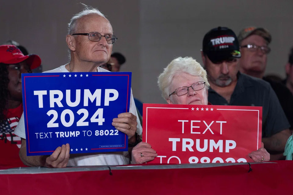 Supporters listen as Former US President Donald Trump speaks at a rally in Waukesha, Wisconsin, May 1, 2024. A recent poll has Trump and President Joe Biden tied in the state.  