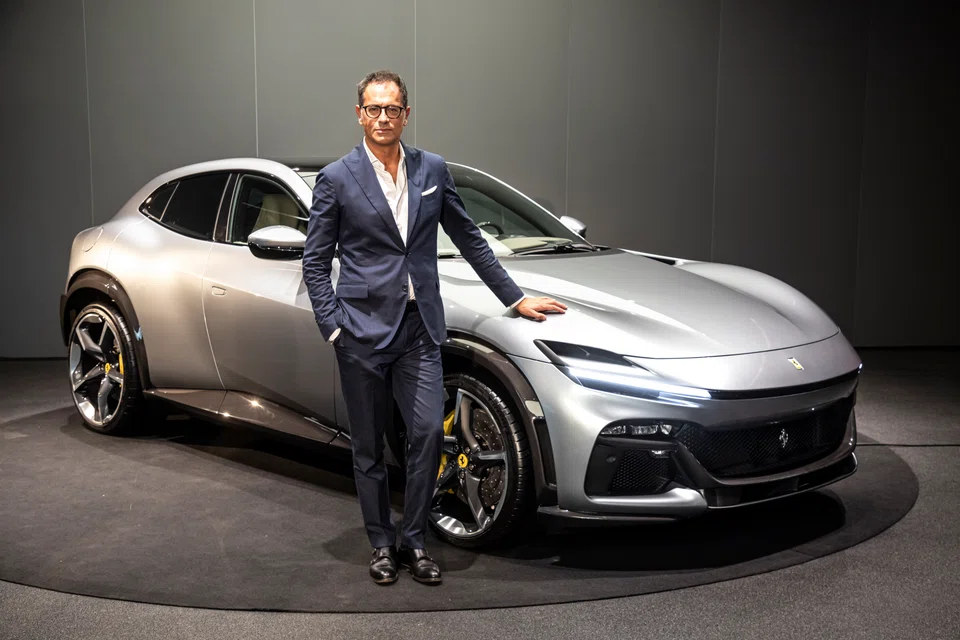 Flavio Manzoni, chief design officer of Ferrari, with the new Purosangue. Manzoni says the Purosangue has a patented wheelarch design, which creates a floating effect that seems to separate the coupe-like body from the mechanical components underneath it. 