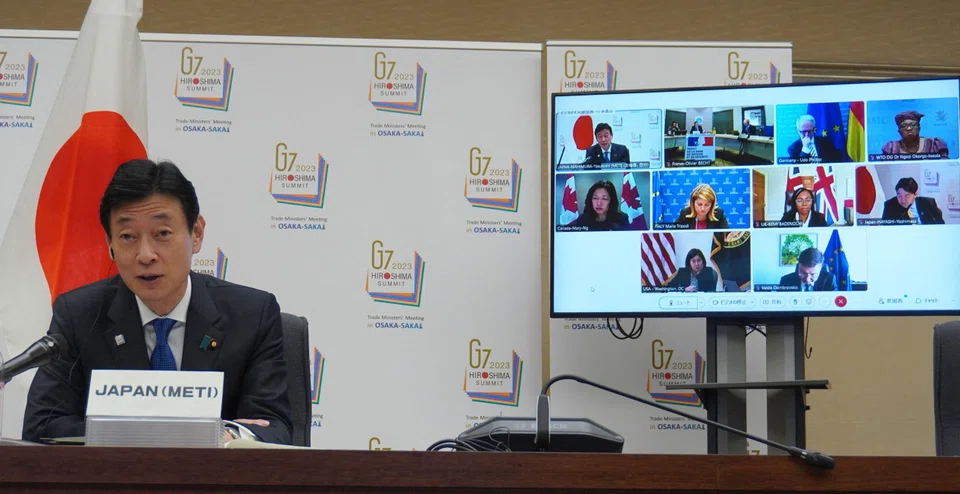 Japan's Economy, Trade and Industry minister Yasutoshi Nishimura (L) speaking in Tokyo at the Apr 4 meeting of the 2023 G7 trade ministers, during which economic security, including export controls, was raised. 