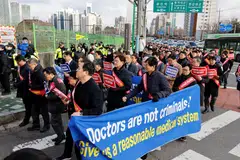South Korean doctors march to protest against the government medical policy in front of the Presidential office in Seoul.