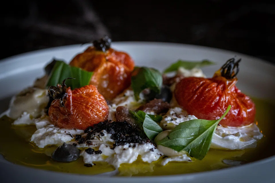 A Jewish take on Italian caprese featured burrata with olives and smoky eggplant.
