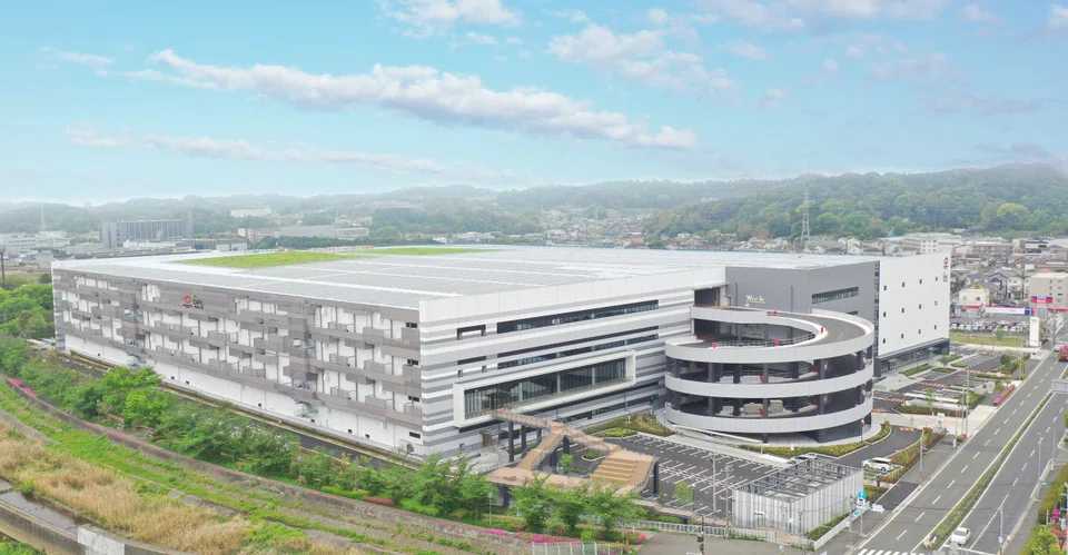 The four-floor facility (above) is in Yokohama, has access to the Greater Tokyo region, and has features that protect it against earthquakes.   