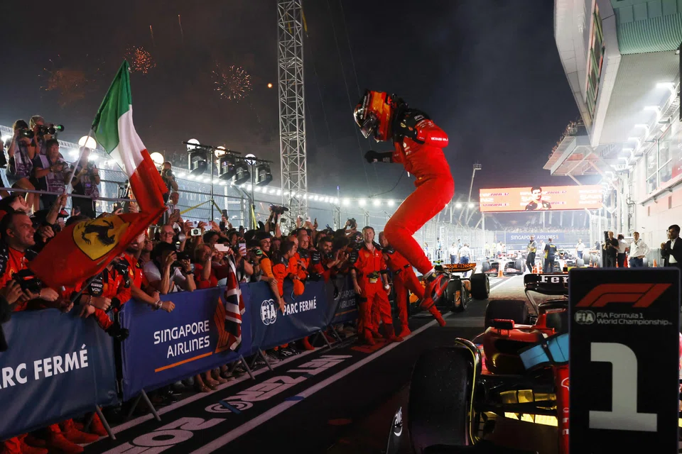 Ferrari's Carlos Sainz Jr celebrating after winning the Singapore Grand Prix.