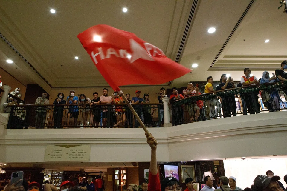 Supporters of the Pakatan Harapan (PH) party wave a flag at an election event in Malaysia on Nov 20, 2022. Malaysia is heading for its first-ever hung parliament after the general election.